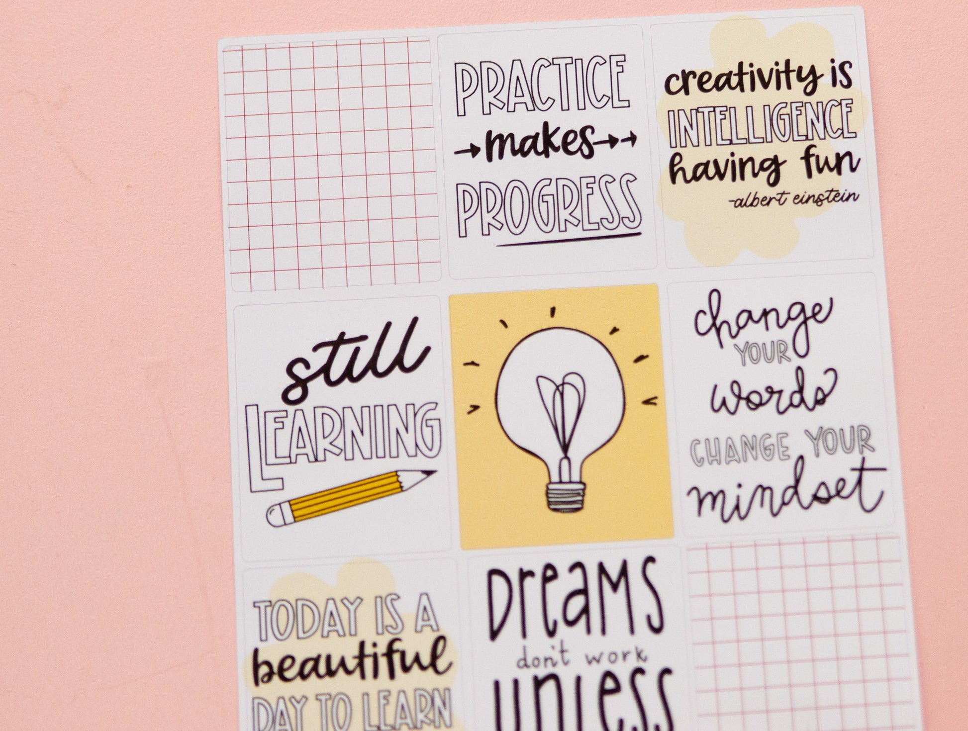 a sheet of stickers with words and a light bulb